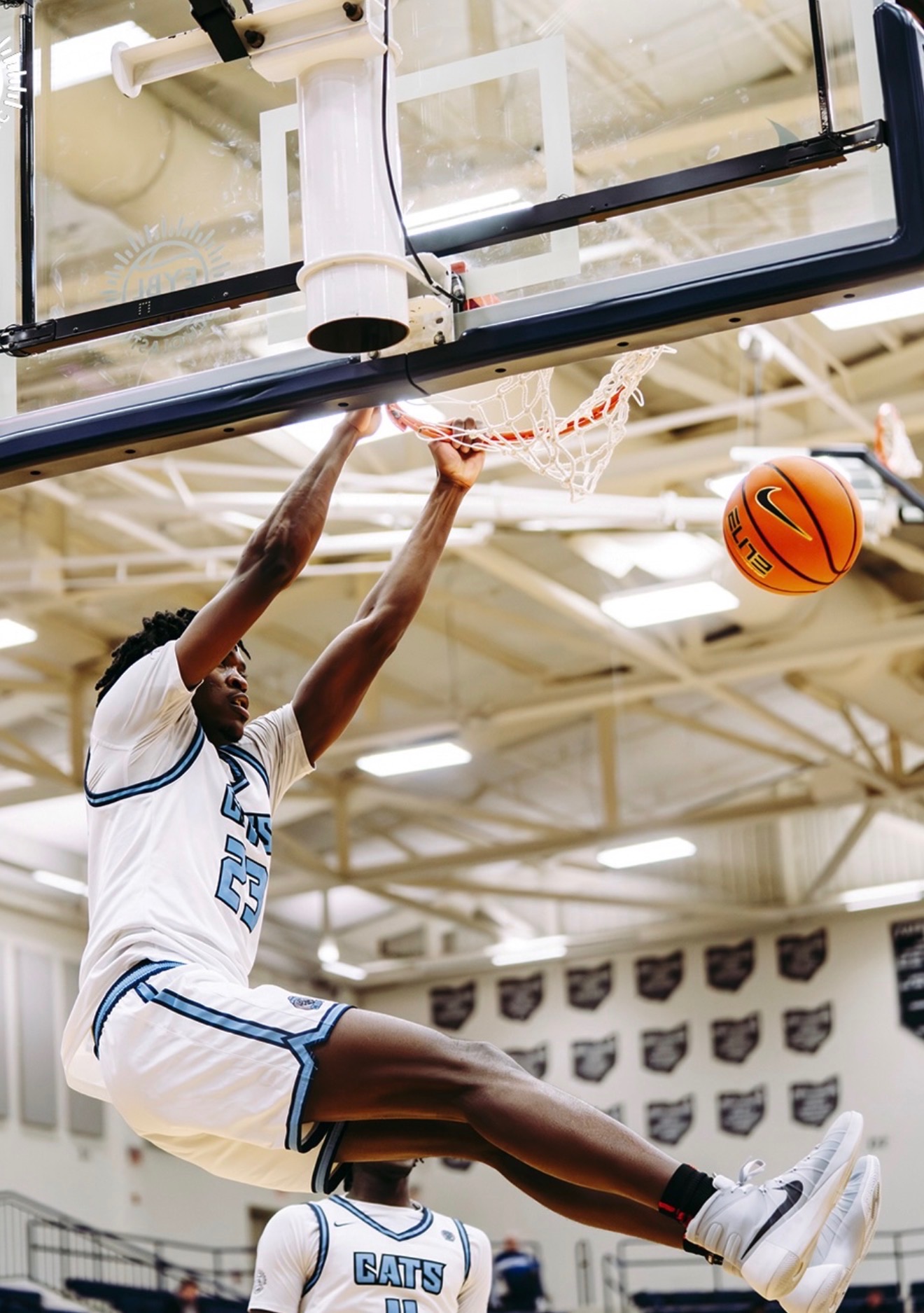 CATS Academy boys basketball player finishing a two-handed dunk during a prep school game
